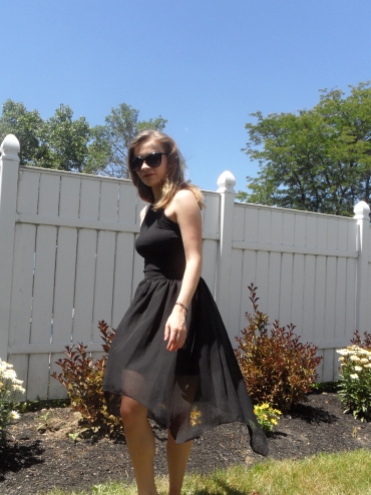 fashion blogger twirling in long black skirt